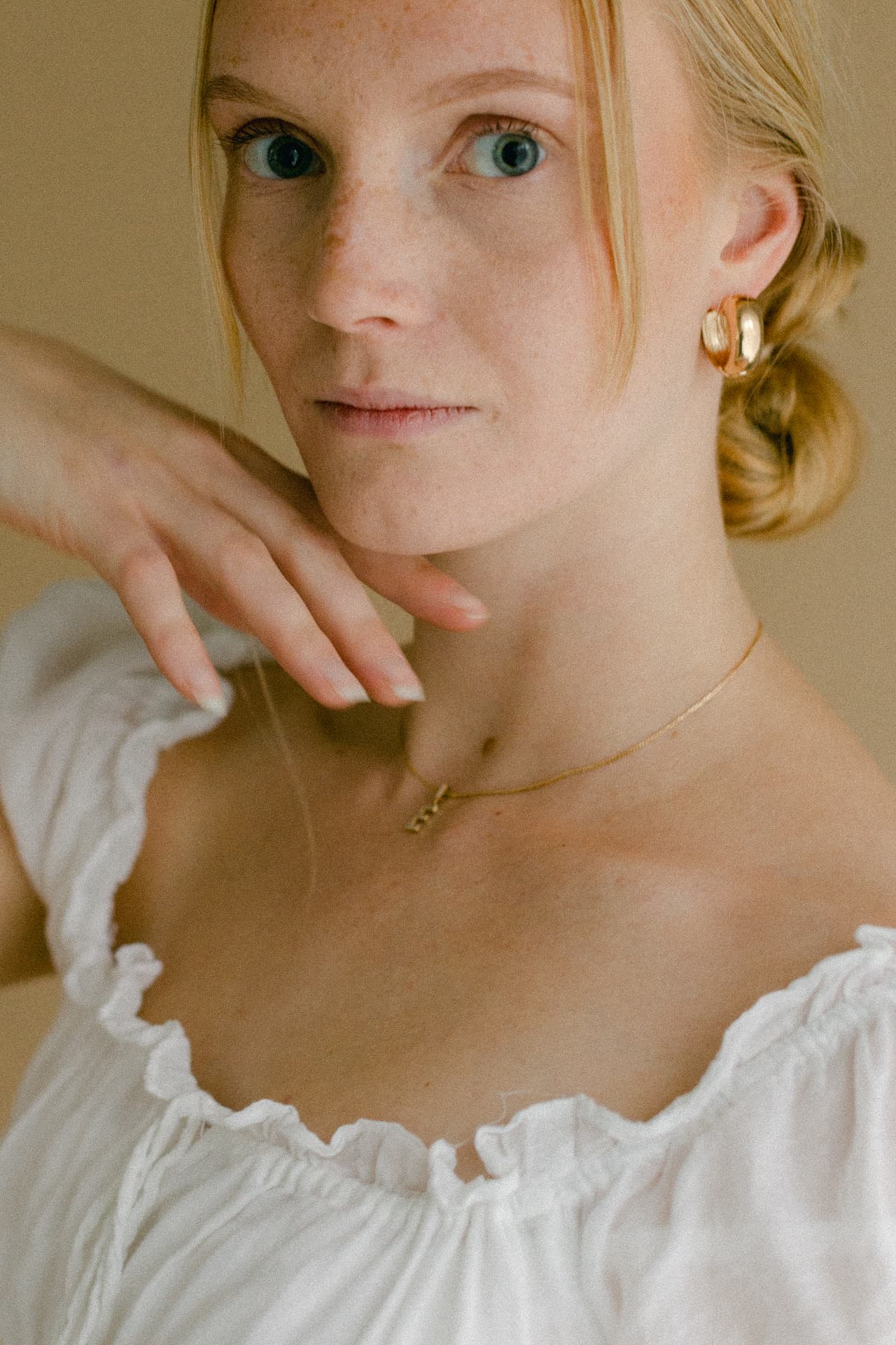 A softly lit portrait of a woman in a white dress
